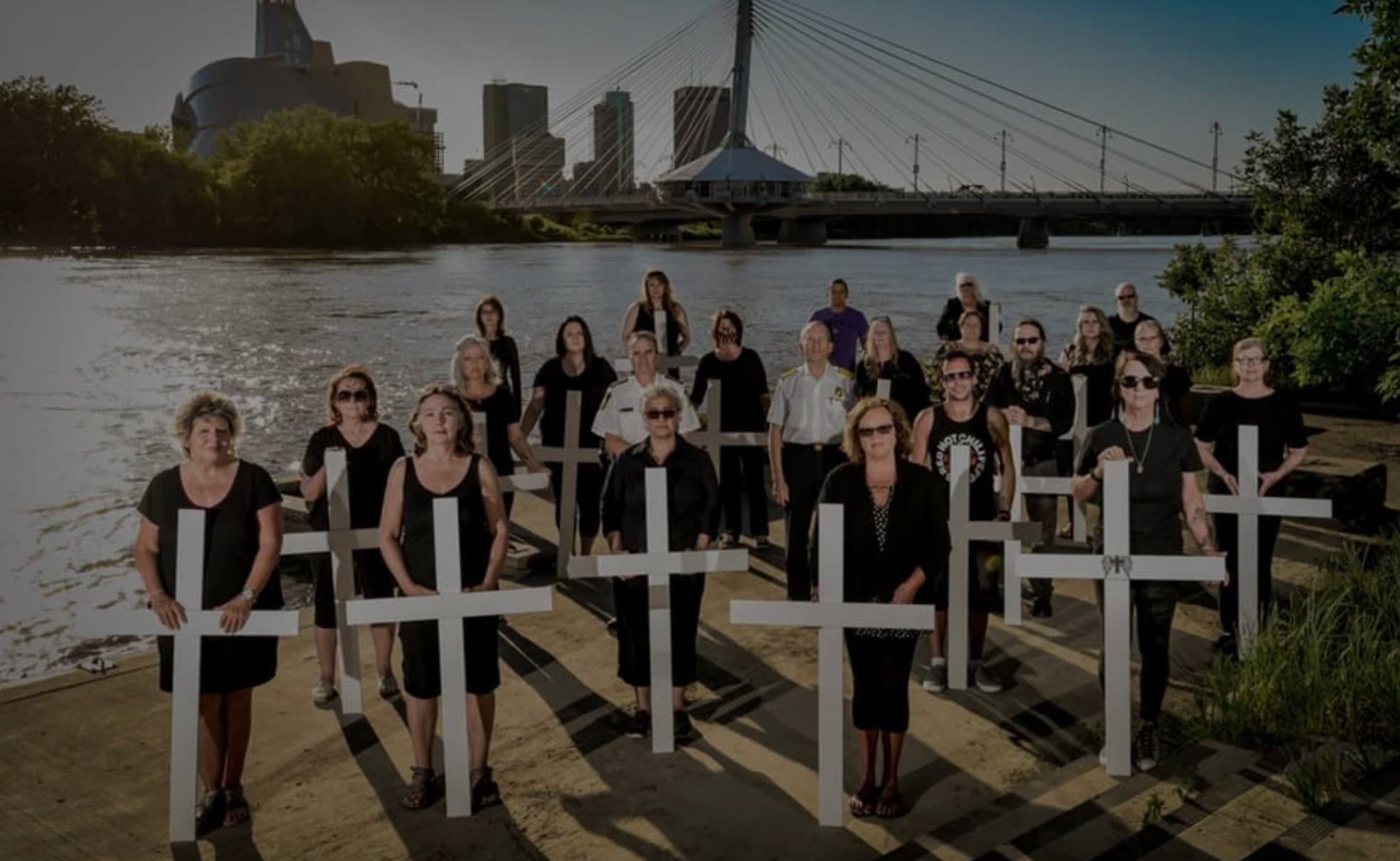 A group of mothers holding crosses wearnig black | moms stop the harm