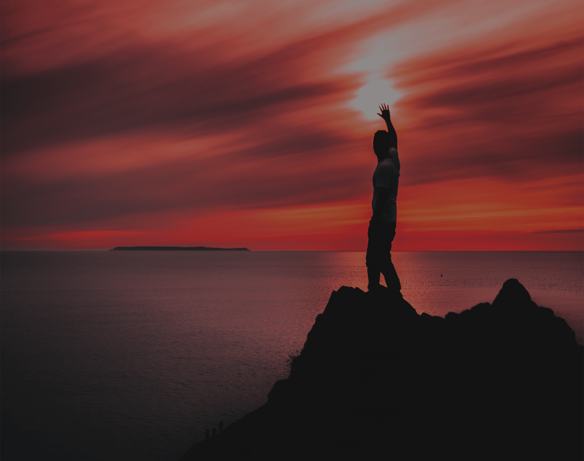 Man waving to a sunset